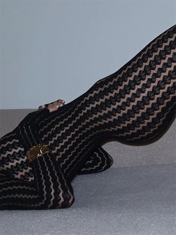 Black seamless mesh jumpsuit with structured jacquard weave and contouring silhouette
