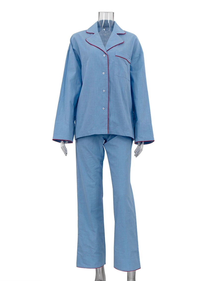 Blue pajama set with red piping on a mannequin against a white background
