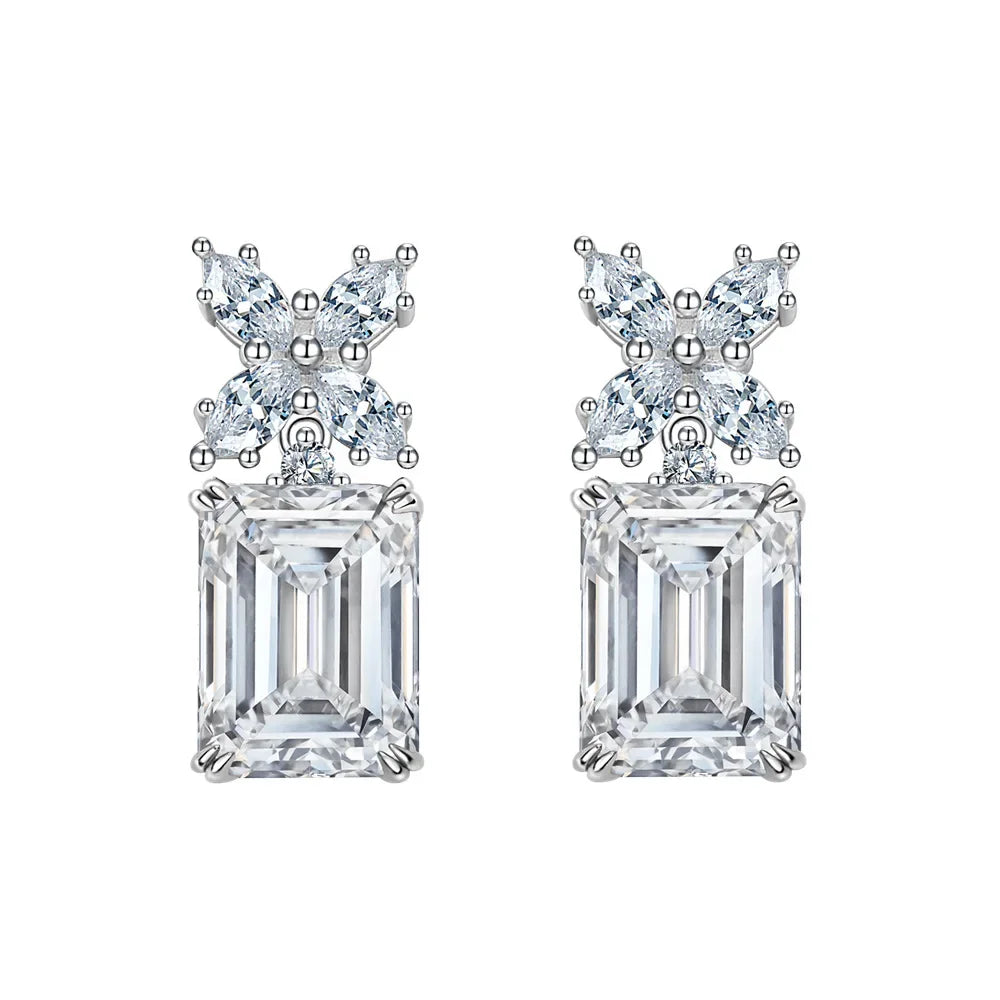 Pair of diamond earrings with emerald-cut stones on a white background