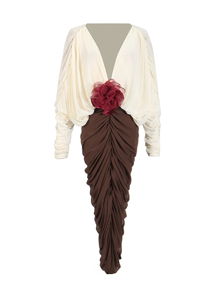 Close-up of 3D flower accent on waist of elegant evening dress.