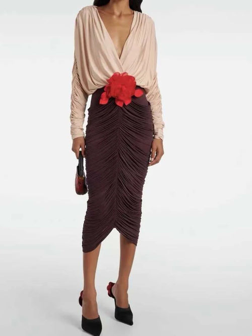 Elegant V-neck two-tone midi dress with pleated skirt and red 3D flower detail – front view.