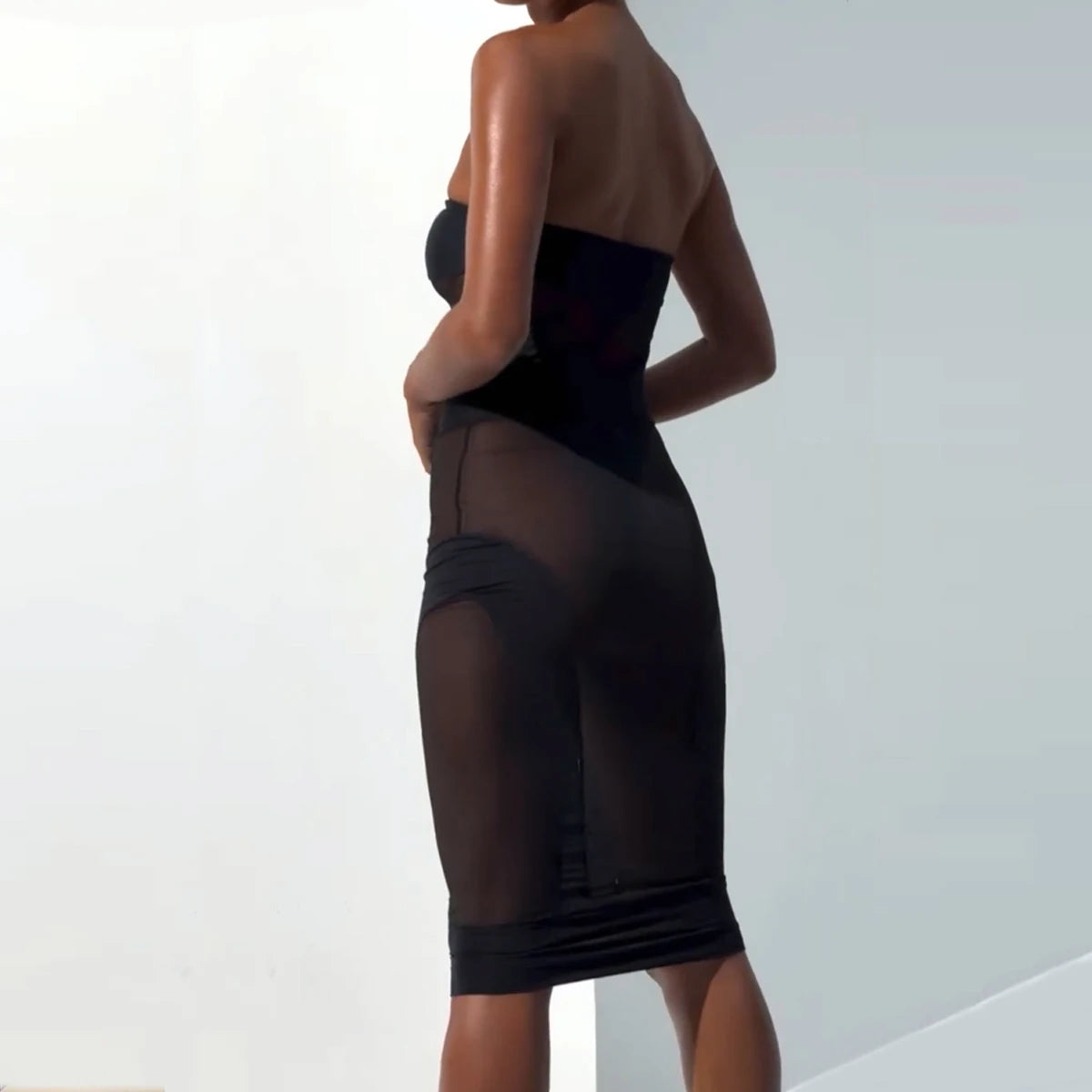 High-waist black mesh skirt and sheer strapless top set with sculpting bodycon design
