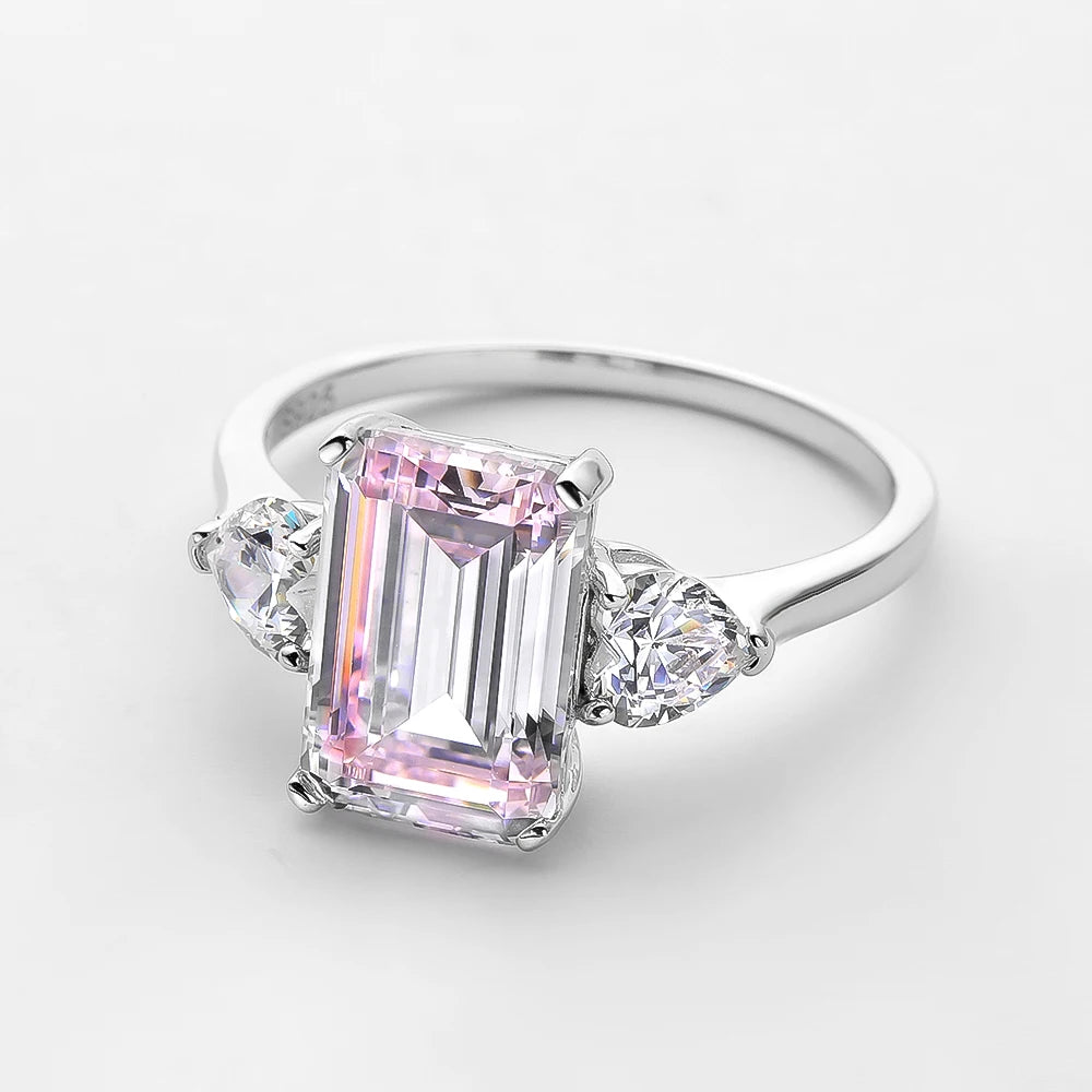 Ring with a pink gemstone and smaller diamonds on a light gray background