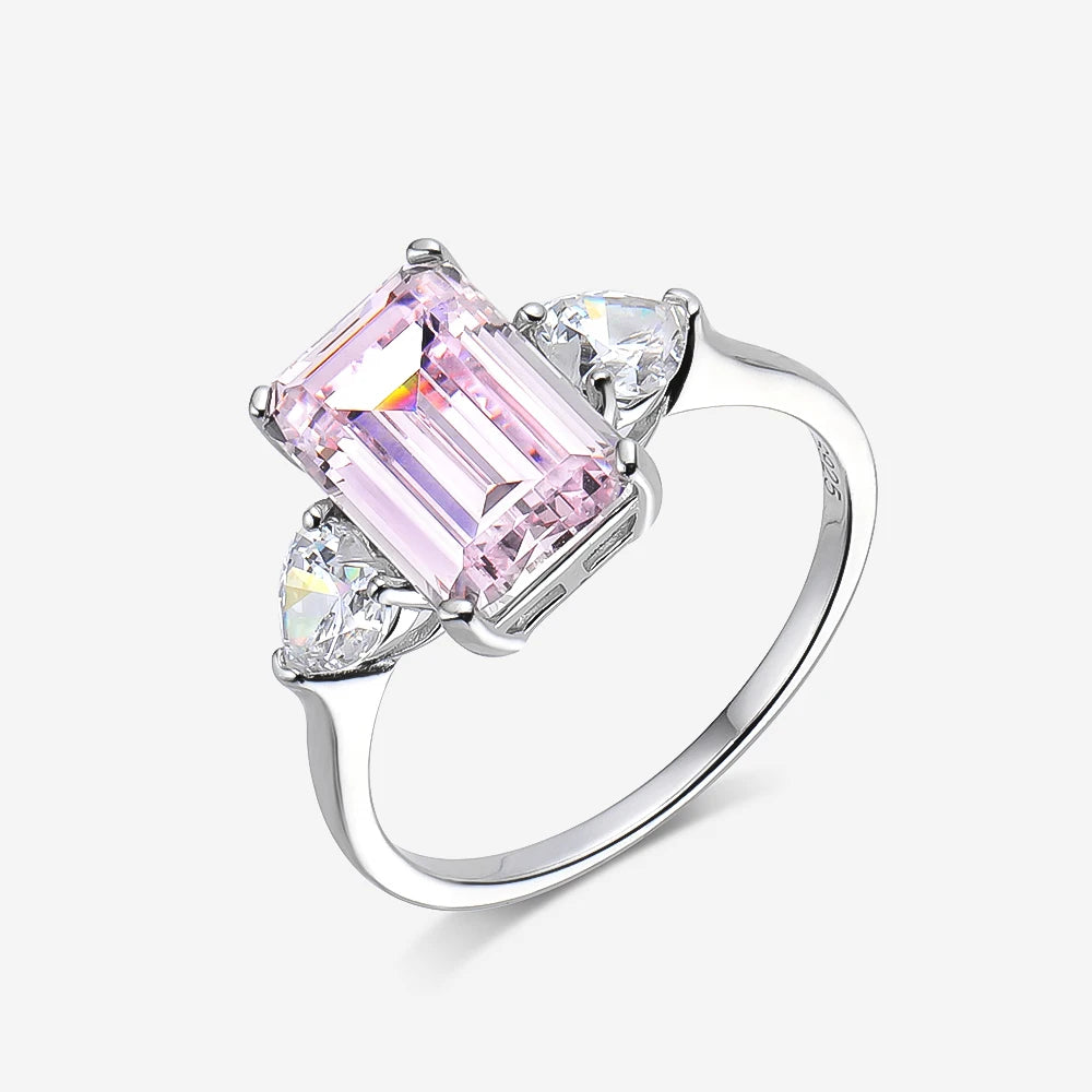 Ring with pink gemstone and clear stones on a white background