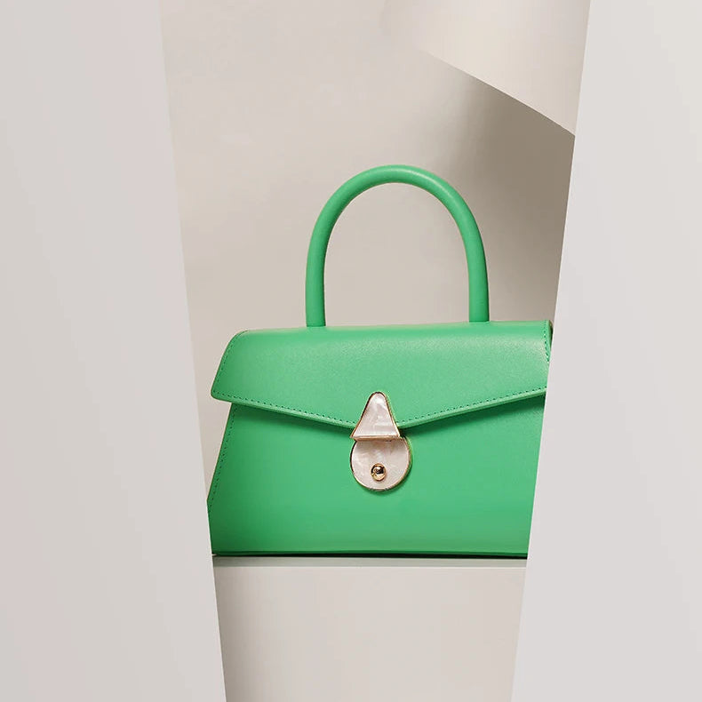 Green handbag with a white background and text 'ENJOY YOUR LOVE'.