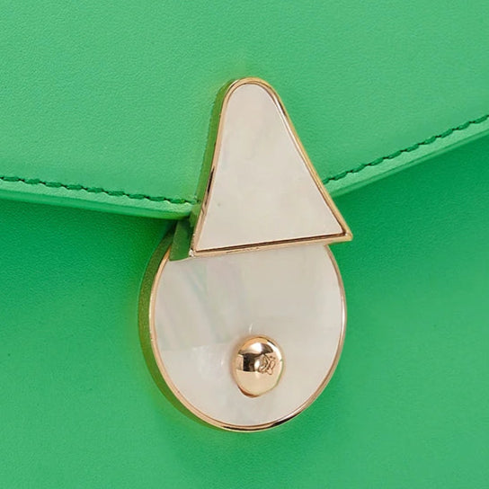 Green handbag with a gold lock on a white background