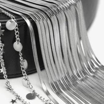 Metal tassels on a black cylindrical container with text 'Metal Tassels' and 'Vintage and fashionable'.