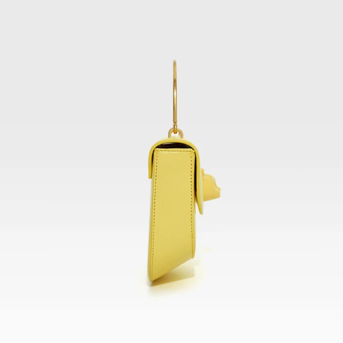 Yellow phone case with gold ring on a white background, featuring the brand 'Bafelli'.