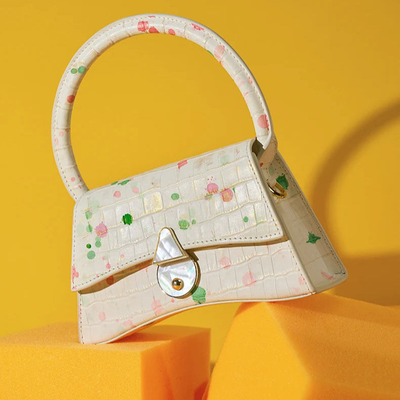 Shell handbag with floral pattern on a yellow background