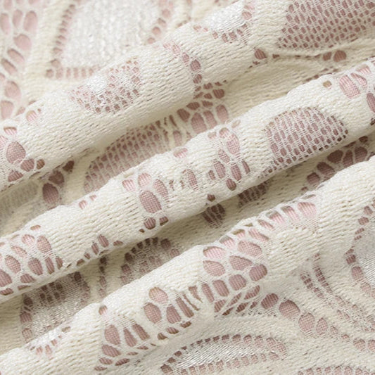 Close-up of lace fabric with a floral pattern on a white background