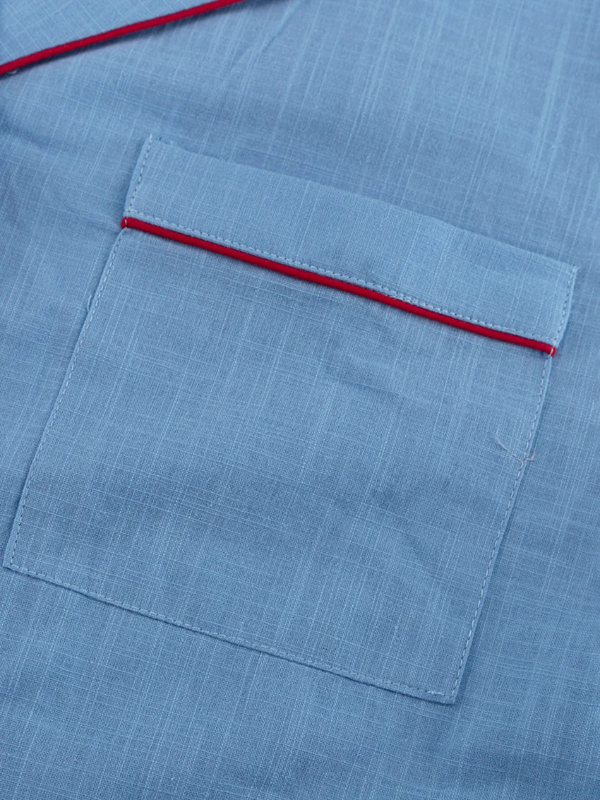 Close-up of a blue fabric pocket with red stitching
