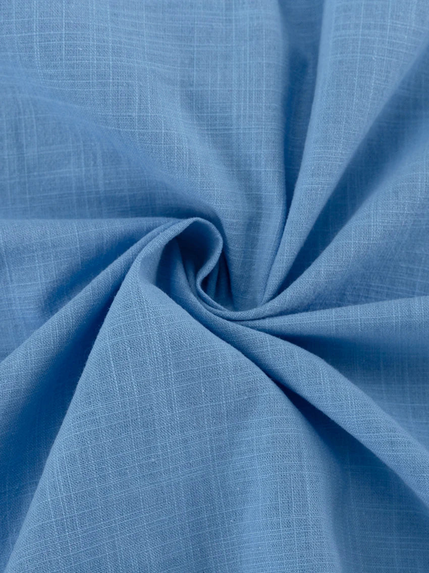 Close-up of blue fabric with a subtle pattern