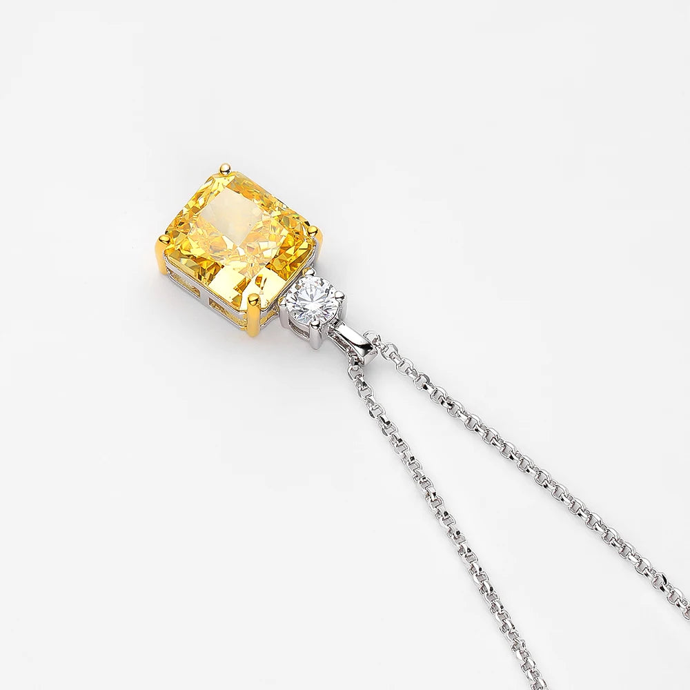 Yellow gemstone pendant on a silver chain against a white background