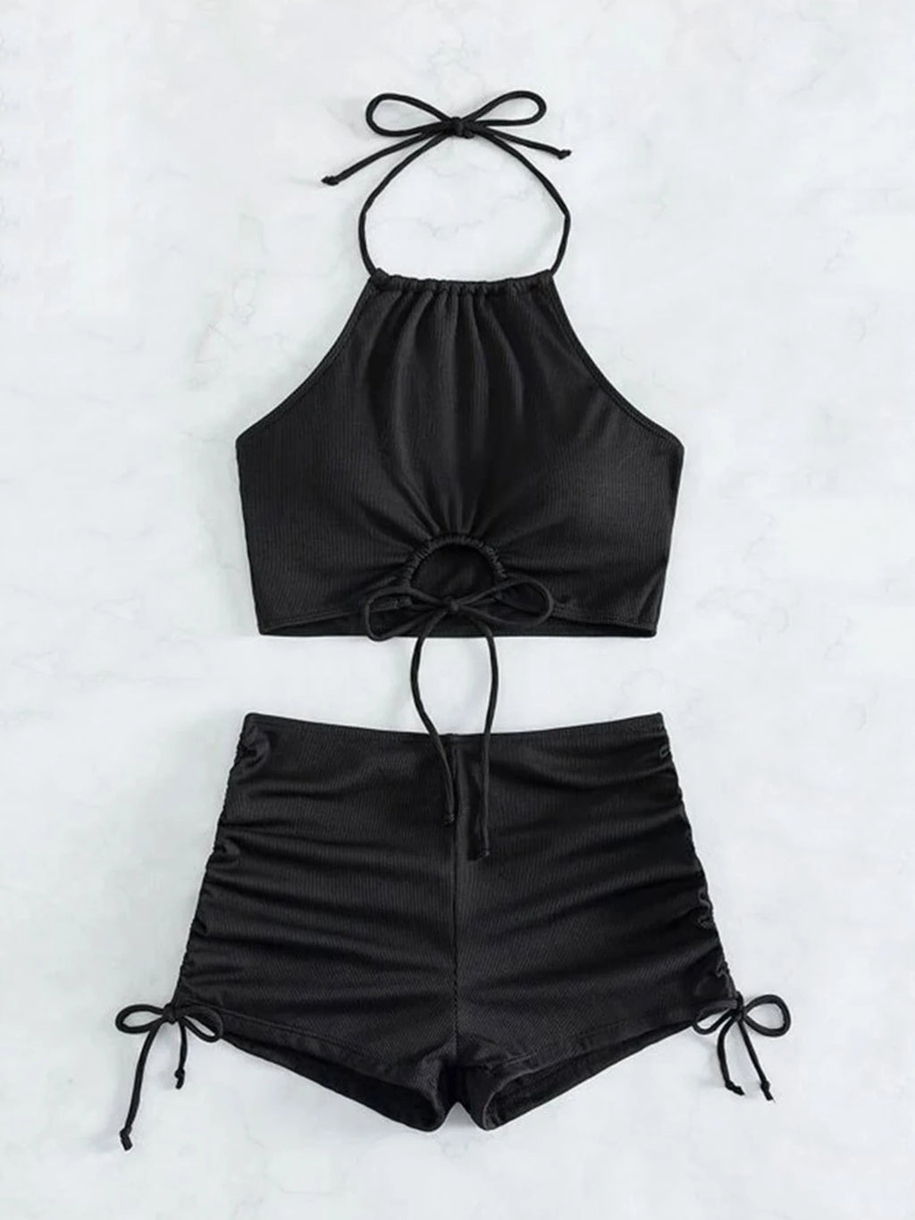 Black halter top and shorts set on a white background