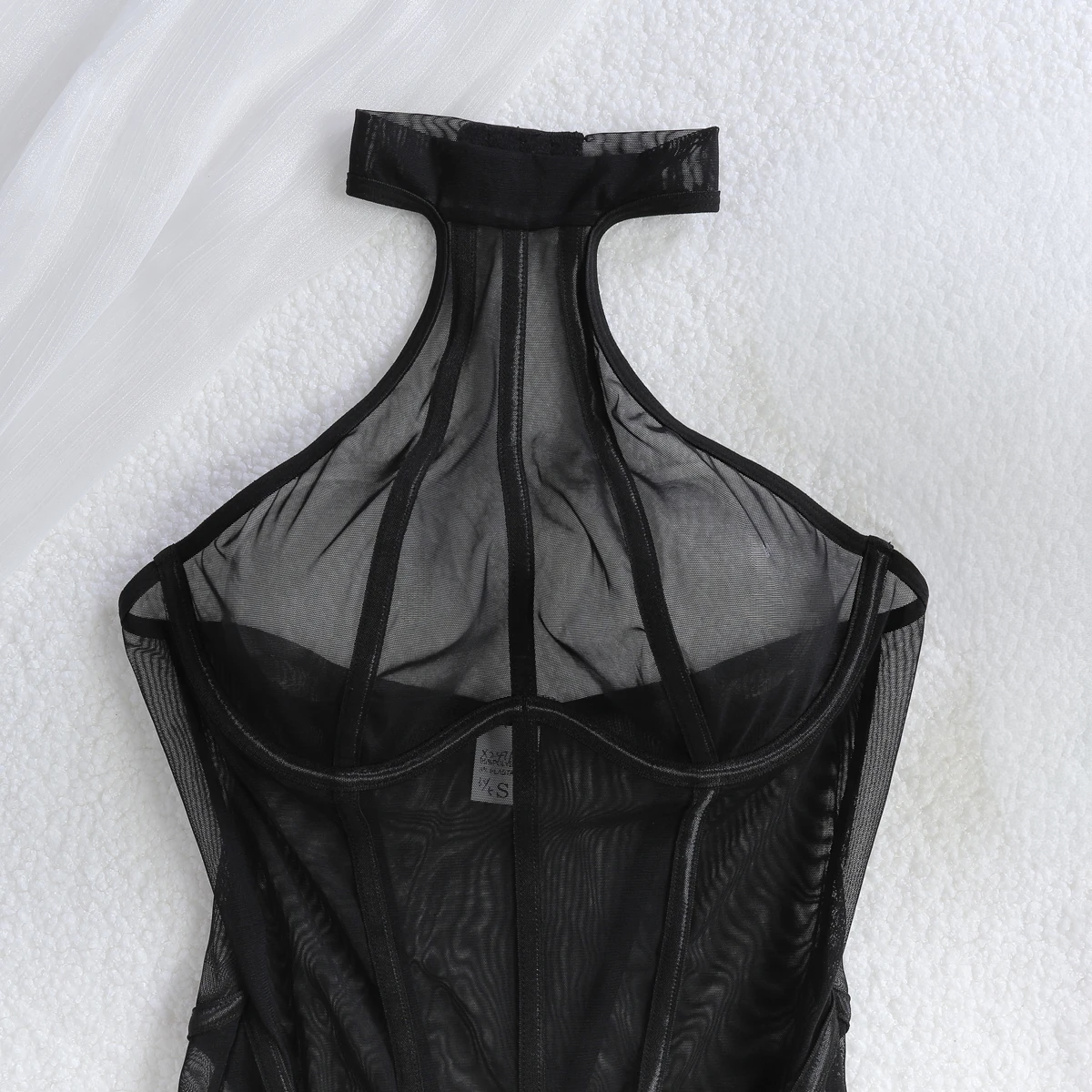 Slim bodycon jumpsuit in black mesh with halter neckline and vertical pattern
