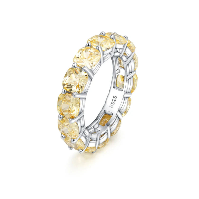 Gold ring with yellow gemstones on a white background