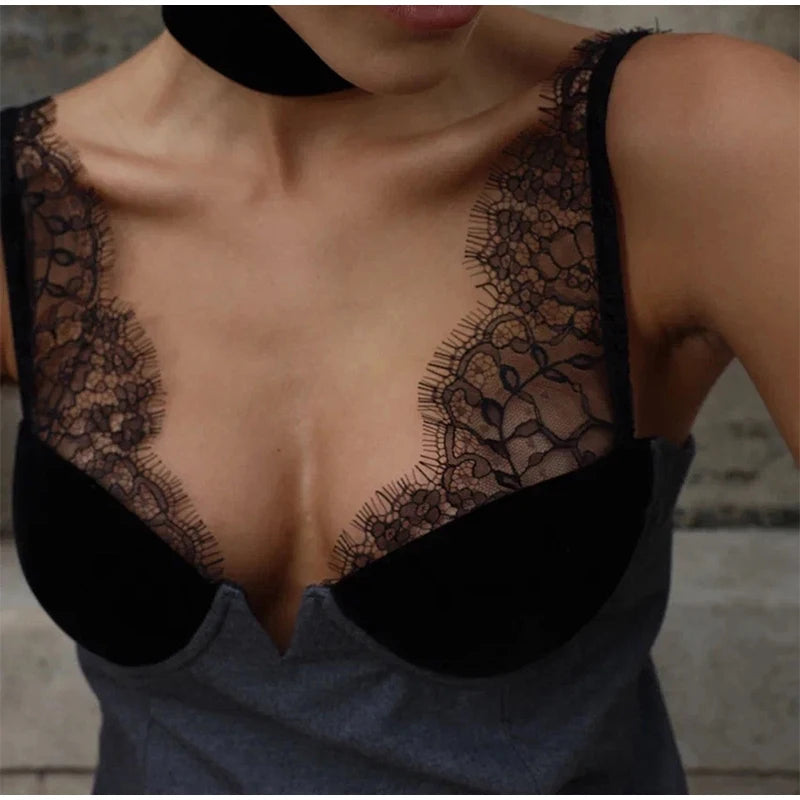 Black lace top worn by a person with a blurred background