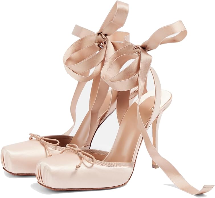 Pair of pink high-heeled shoes with ribbon straps on a white background