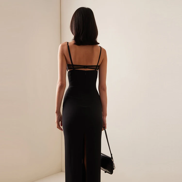 Backless black bodycon evening gown with sheer mesh paneling and leg slit