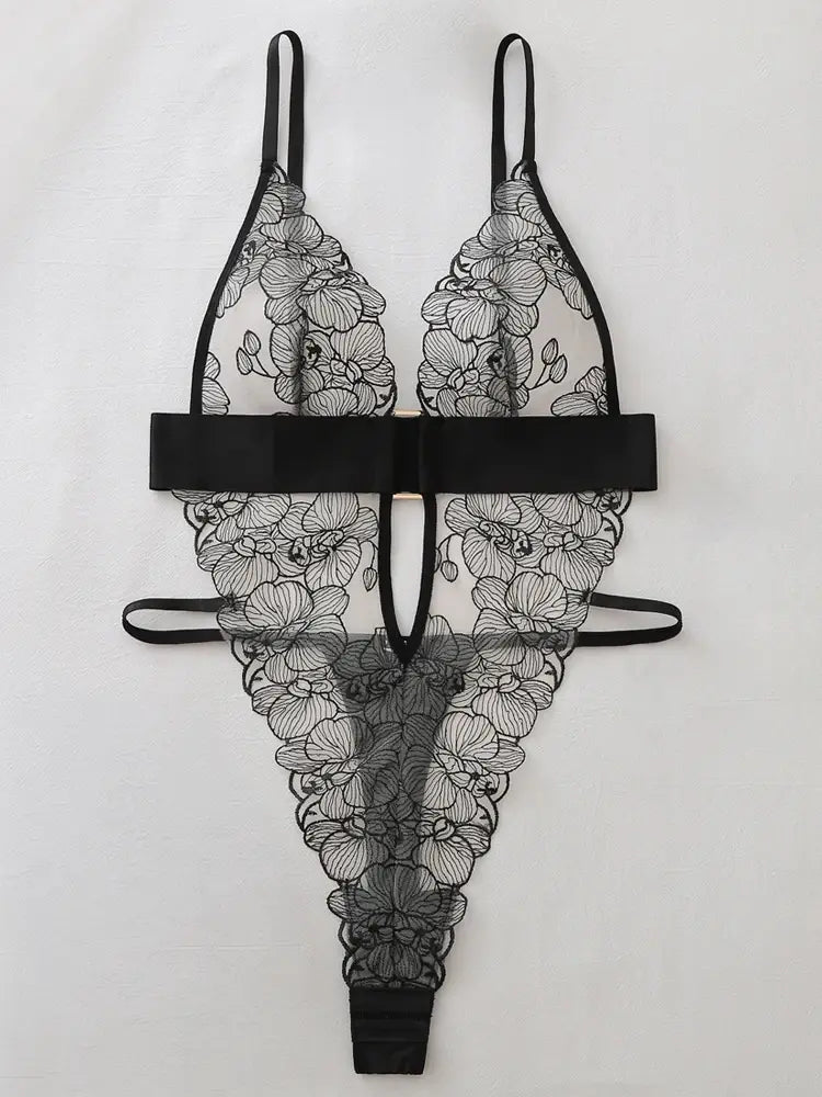 Black floral embroidery and plunging neckline detail on sheer teddy lingerie