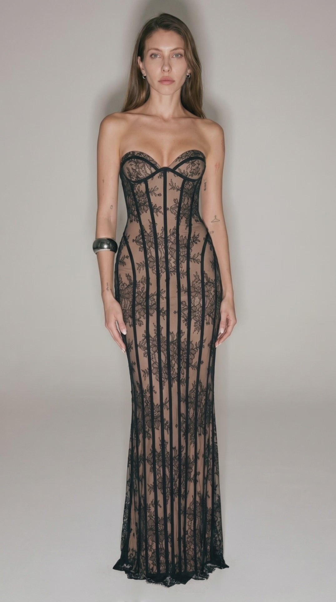 Black strapless lace dress with corset structure and long fitted silhouette
