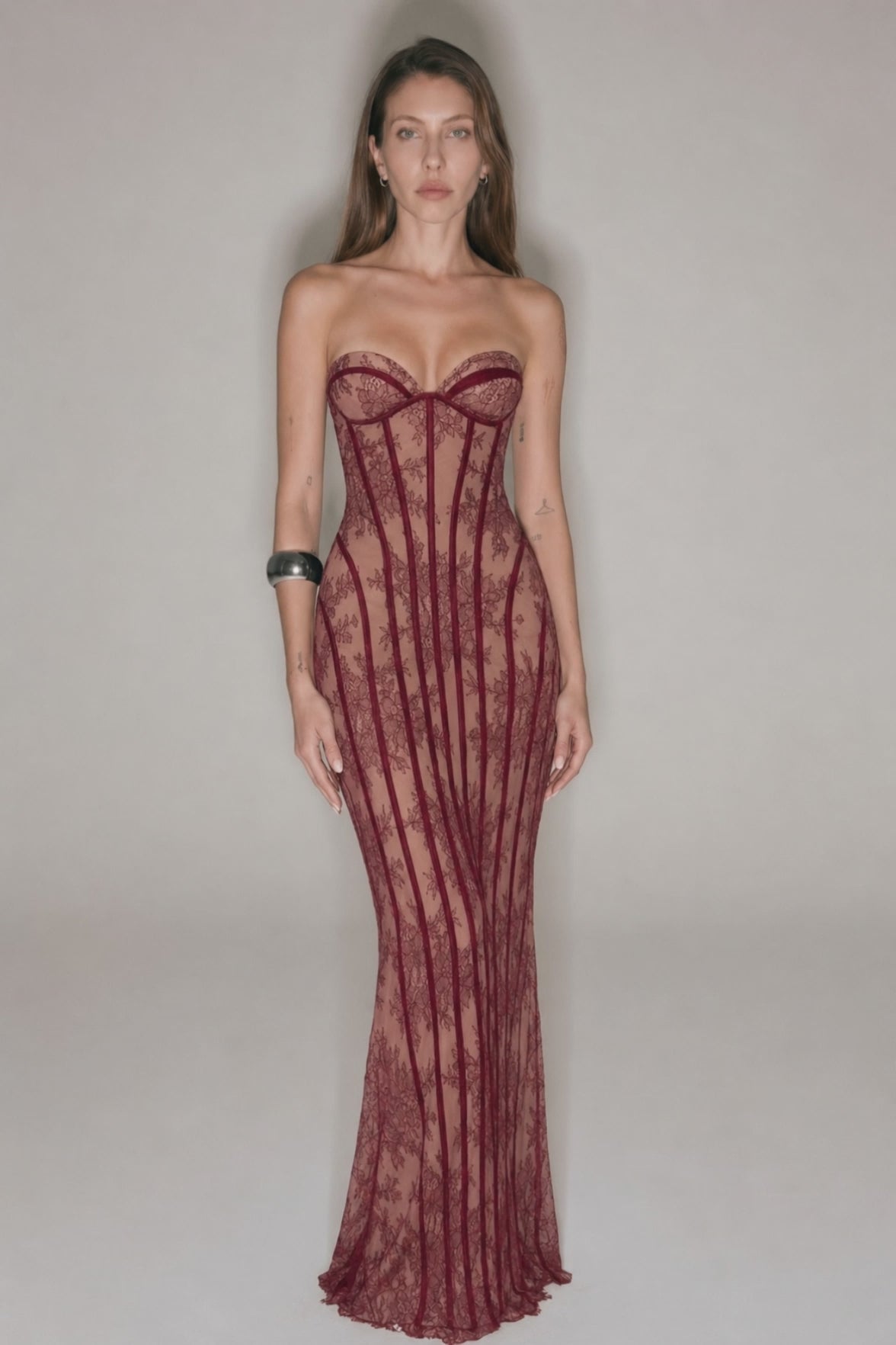 Romantic burgundy lace gown with strapless neckline and feminine evening